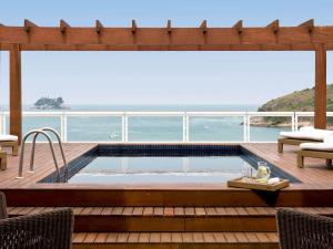 a swimming pool on the deck of a cruise ship at Hotel Jequitimar Guaruja Resort & Spa by Accor in Guarujá