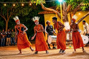 a group of men in indian costumes performing a dance at Aatman Forest Resort - A Luxury Stay in Sasan Gir in Sasan Gir +44 photos