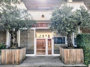 a building with two trees in front of it at The pool house - Il Gabbiano in Palau