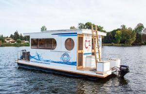 a house boat floating on the water at Lisa Boot 3 in Priepert