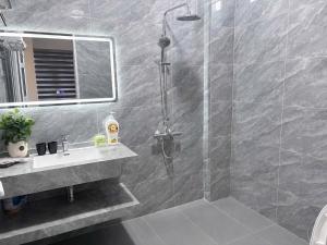 a bathroom with a shower and a sink at Moon Room in Hai Phong