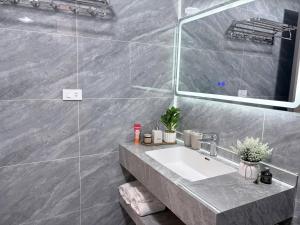 a bathroom with a sink and a mirror at Moon Room in Hai Phong