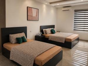 a bedroom with two beds and a window at Moon Room in Hai Phong