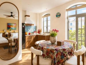 a kitchen and dining room with a table and a mirror at Vistalago Hotel Khem Beach Phu Quoc in Phú Quốc