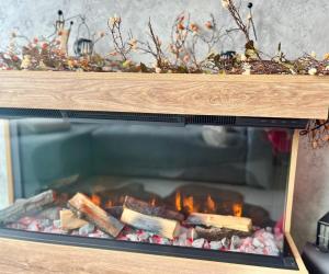 a fire in a woodburning oven in a room at Balkan tower REST 2 Безплатно паркомясто in Gabrovo