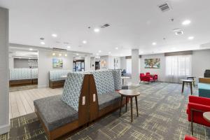 a waiting room with a couch and a table at Hampton Inn Salem in Salem