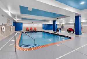 a large swimming pool in a building with blue walls at Hampton Inn Salem in Salem