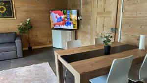 a living room with a wooden table and chairs at Chalet Montes in Lauterbrunnen