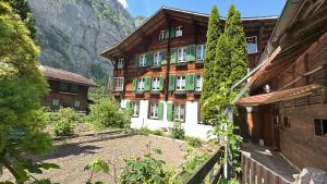 a house in the middle of a mountain at Chalet Montes in Lauterbrunnen