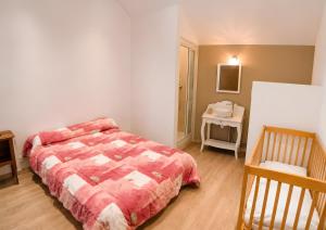 a bedroom with a bed and a table with a night stand at La Maison des Filles in Sainte-Scolasse-sur-Sarthe