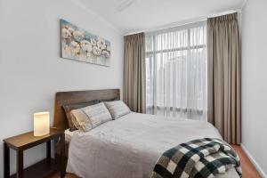 a bedroom with a bed and a window at 4 1 Harbour View Terrace BYO Linen in Victor Harbor