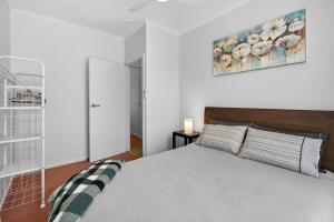 a bedroom with a bed and a painting on the wall at 4 1 Harbour View Terrace BYO Linen in Victor Harbor