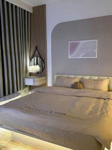 a bedroom with a large bed and a window at Lumi Homestay in Phú Thú