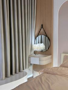 a bedroom with a bed and a mirror at Lumi Homestay in Phú Thú +8 photos