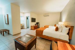 a hotel room with a bed and a table at Comfort Inn Tampico in Tampico