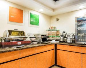 a restaurant kitchen with a counter with food at Quality Inn Ashland in Ashland