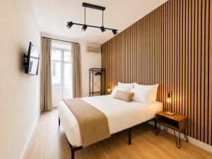 a bedroom with a large white bed and a window at Casa Antares Granada in Granada +179 photos
