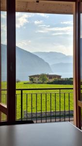 a view of a field from a window at La finestra sul lago in Clusane sul Lago