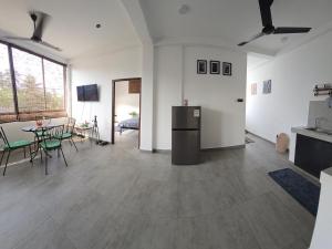 a living room with a table and a dining room at Urban tropics in Colombo +22 photos
