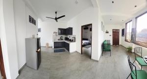 a living room with a refrigerator and a kitchen at Urban tropics in Colombo