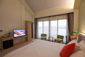 a hotel room with a bed and a television at Gancheng 35 in Jian +11 photos