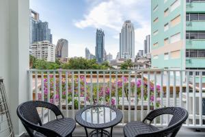 a balcony with chairs and a view of a city at Mac's House in Bangkok