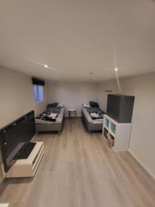 a large living room with two beds and a fireplace at Local home apartment in Stavanger in Stavanger
