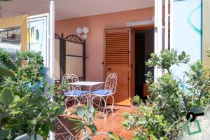 a patio with a table and chairs on a balcony at Hotiday Taormina Mazzeo in Taormina