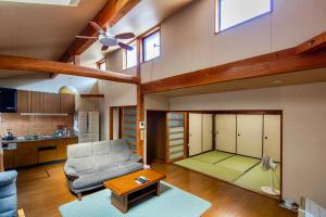a living room with a couch and a table at 古民家一棟貸 鴨部巣 kamobese in Kochi