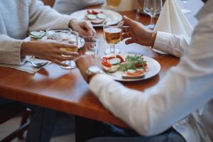 a group of people sitting around a table with drinks at Hotelli Helmi in Turku +34 photos