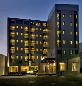 a tall building with lights in the night at Joy Inn in Lugang