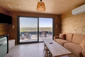 a living room with a couch and a table at Lodge Spa Celeste in Sarlat-la-Canéda