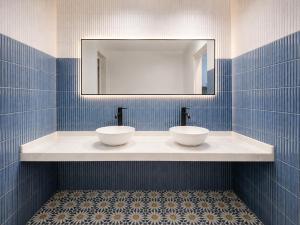 a bathroom with two bowls on a counter with a mirror at Casa Antares Granada in Granada