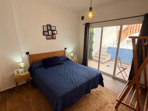 a bedroom with a bed and a sliding glass door at Enamórate con vistas al mar en La Marina House in La Alcazaba +24 photos