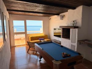 a pool table in a living room with a view of the ocean at Enamórate con vistas al mar en La Marina House in La Alcazaba