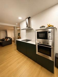 a kitchen with a stove and a microwave at Tranquilo in Elche