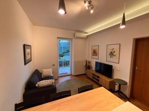 a living room with a table and a couch at Porto Albona in Rabac