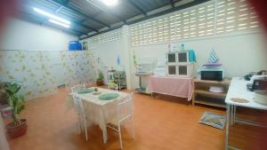 a room with a table and a microwave in it at Pai Town Home in Pai