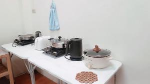 a kitchen counter with pots and pans on it at Pai Town Home in Pai