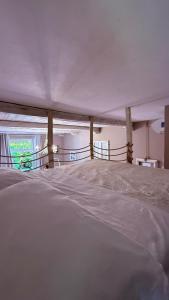 a large bed in a room with a window at Casa Everest in Malgrate