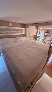 a large bed in a room with at Casa Everest in Malgrate