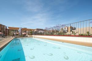 a swimming pool on the roof of a building at Áurea Palacio de la Tinta by Eurostars Hotel Company in Málaga