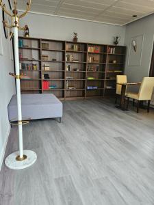a room with bookshelves and a couch and a table at Moocks Hotel in Altenau