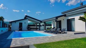 a swimming pool in the backyard of a house at Luxury Villa Domino with Heated Pool in Mostar