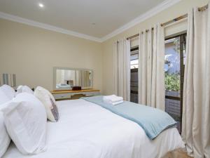 a white bed in a room with a window at Seagull Villa in Margate +22 photos