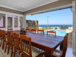 a dining room with a table and a view of the ocean at Seagull Villa in Margate