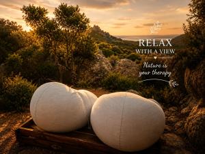 two white balls sitting on top of a wooden table at La Cera Farm Camping B&B in Santa Teresa Gallura