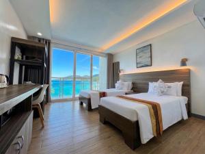a hotel room with two beds and a view of the ocean at Coron Underwater Garden Resort in Coron +111 photos