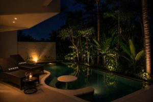 a swimming pool in a resort at night at The Seven Stars Resort in Ishigaki Island