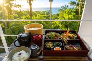 a tray of food sitting on a table with rice at The Seven Stars Resort in Ishigaki Island +98 photos